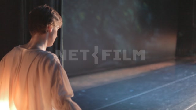 A ballet dancer runs onto the stage (shot from behind the scenes)