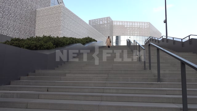 The Yeltsin Center in Yekaterinburg, modern buildings, a woman and a girl climbing a wide staircase