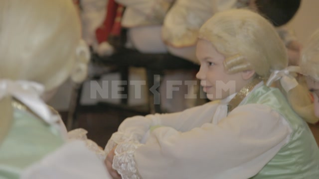 Pupils of the ballet school in stage costumes and wigs before the start of the performance
