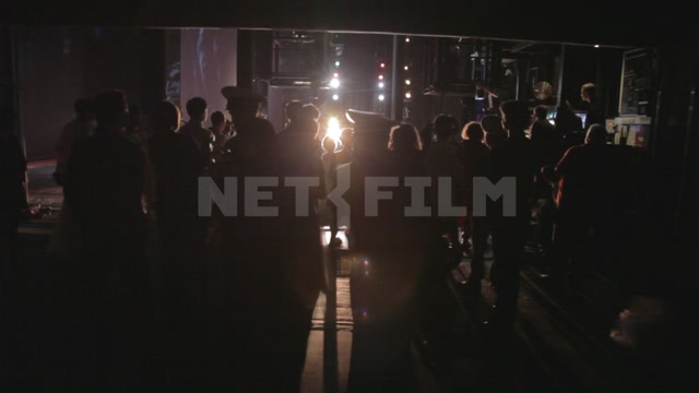 Ballet dancers watch the stage from behind the scenes