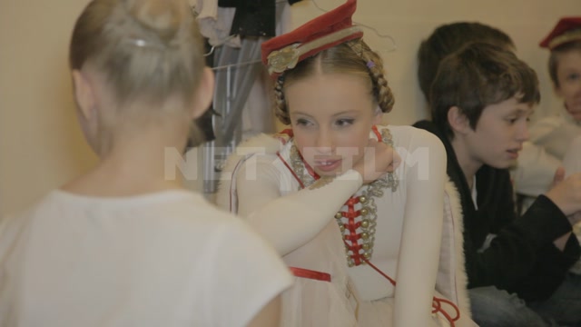 Children (students of the ballet school) in stage costumes before the start of the performance