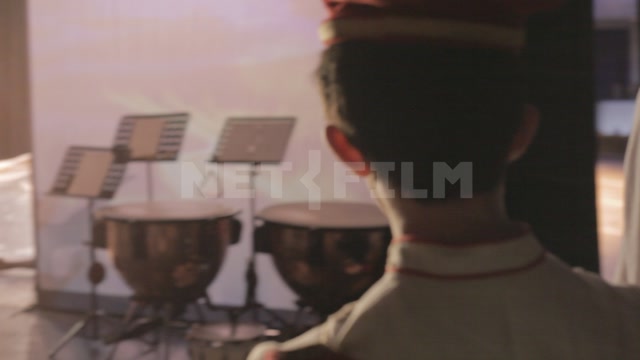 Children (students of the ballet school) watch the stage from behind the scenes. Ballet dancers are