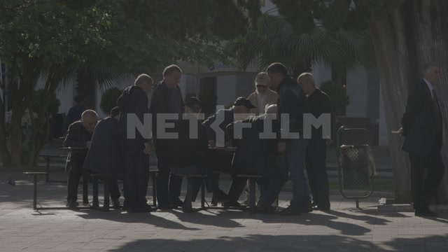 Абхазия, Сухум, лето, день. Абхазские мужчины на набережной, сидят за столом, общаются