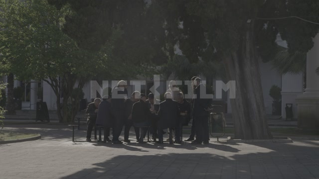 Абхазия, Сухум, лето, день. Набережная, сквер, мужчины сидят за столом, общаются