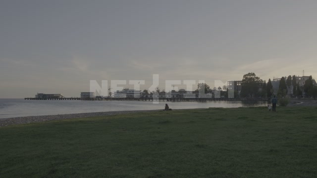 Abkhazia, Sukhum, evening. Embankment, Black Sea. The port and sea terminal are visible in the