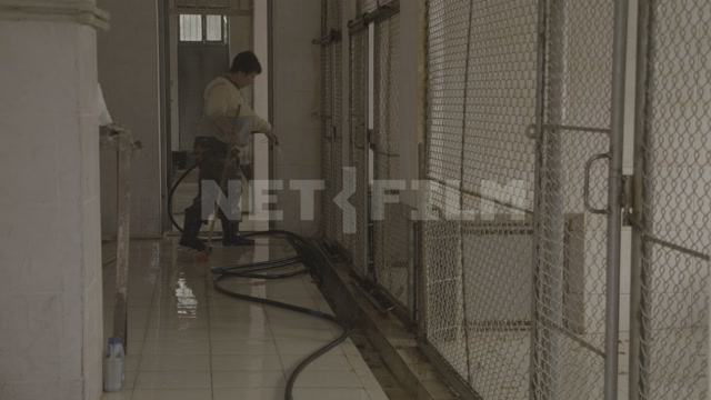 Abkhazia, Sukhumi, monkey nursery, a female employee inside the building cleaning the enclosures